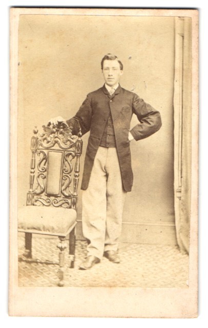 Photograph H. J. Hughes, Carnarvon, Young Man in Suit Posing Next to a St