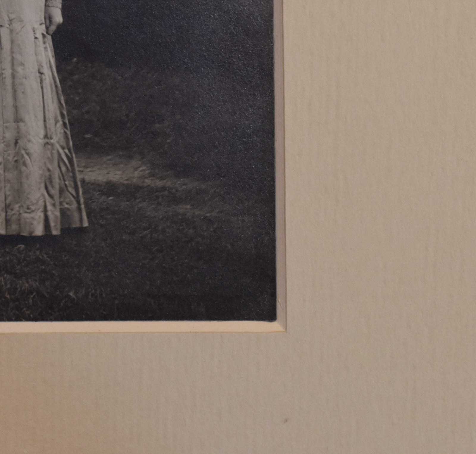 Vintage Photograph of a Woman Wearing a White Dress and a Black Hat