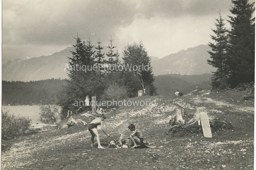 Boys by fire camping in mountains antique art photo