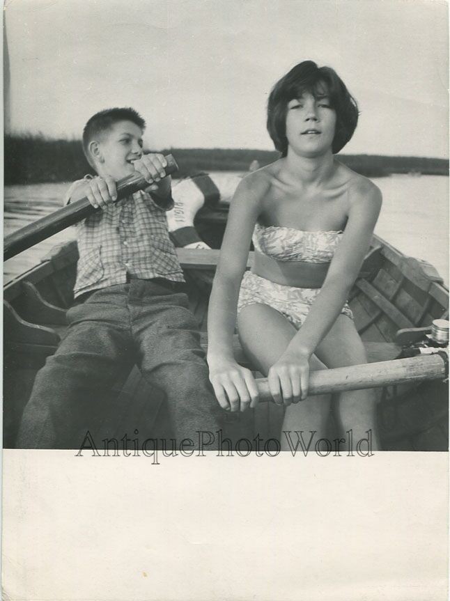 Boy and girl rowing a boat vintage art photo by Vladimir Gailis