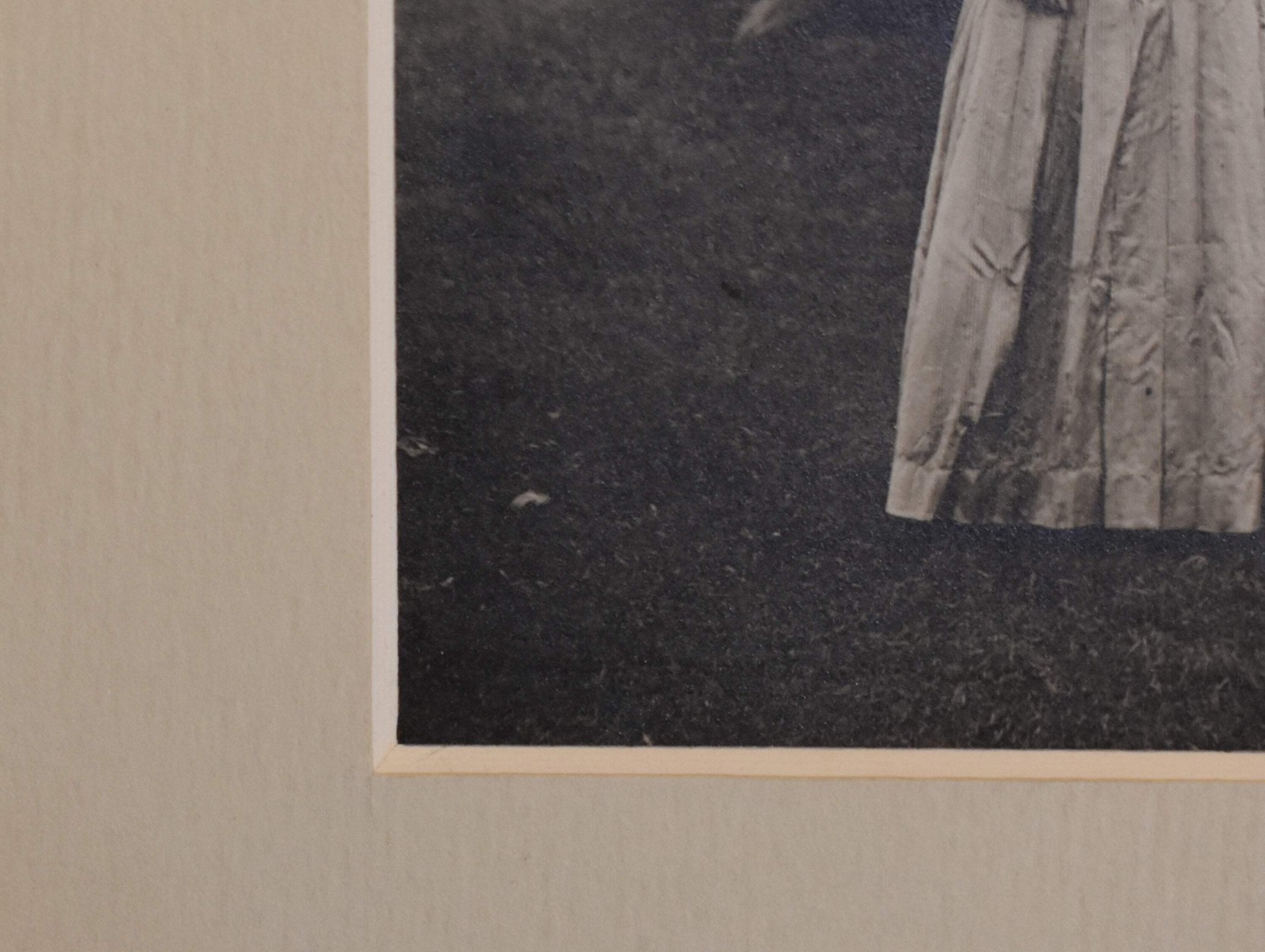 Vintage Photograph of a Woman Wearing a White Dress and a Black Hat
