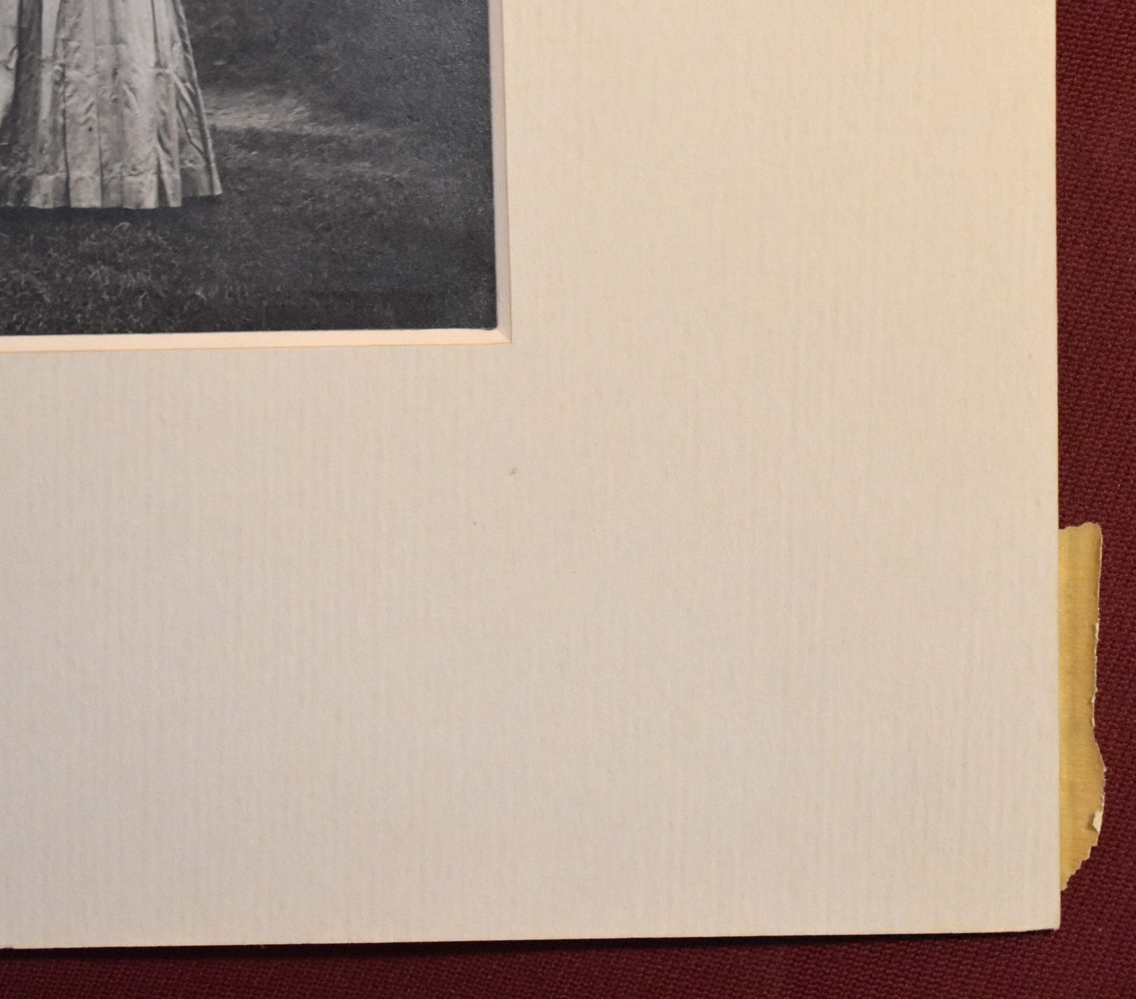 Vintage Photograph of a Woman Wearing a White Dress and a Black Hat