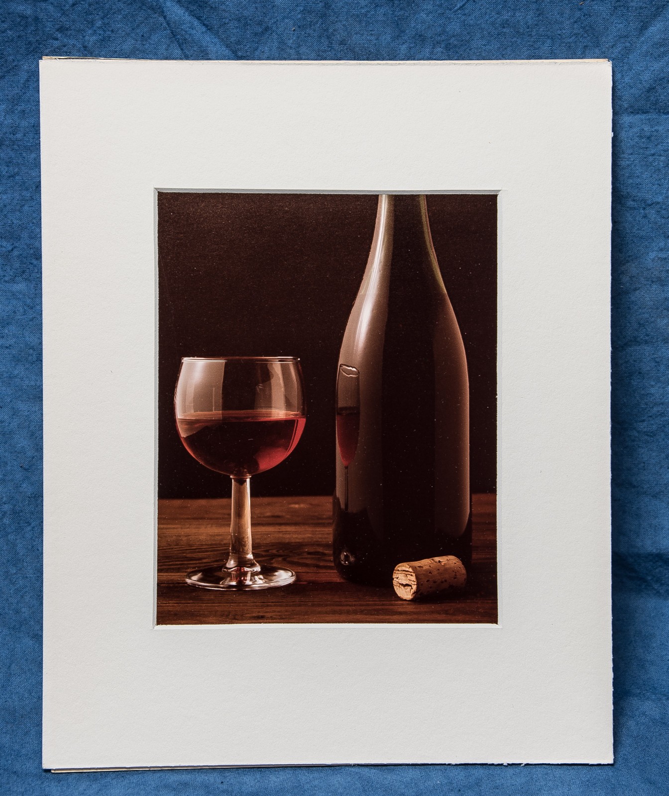 Wine Glass & Bottle with cork wood table black background photograph