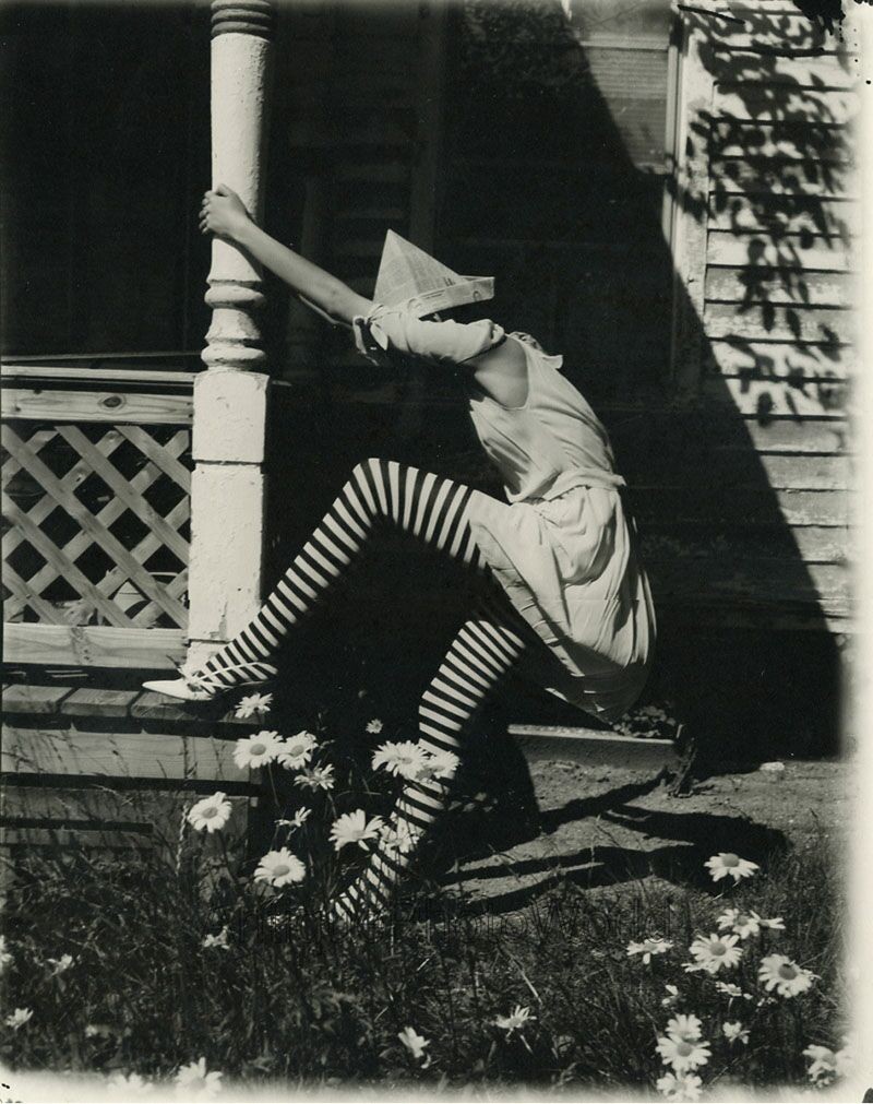 Woman in striped stockings newspaper hat climbing porch strange art large photo