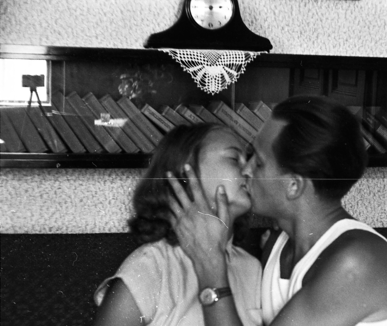 young couple kissing, photo camera on tripod, glass reflection, unusual, vintage