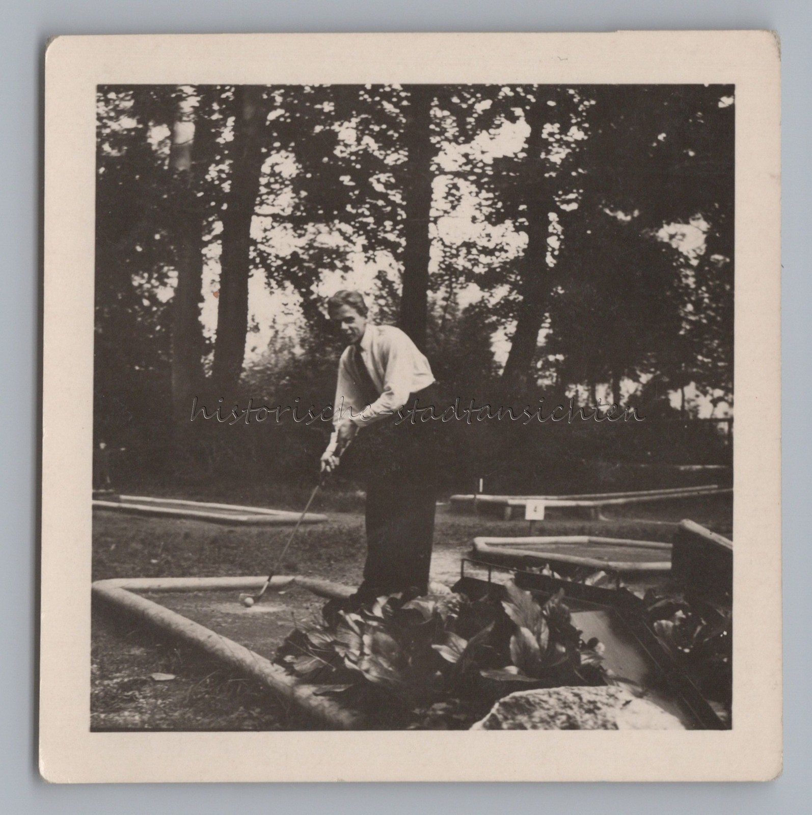 Boy playing mini golf – mini golf leisure – old photo