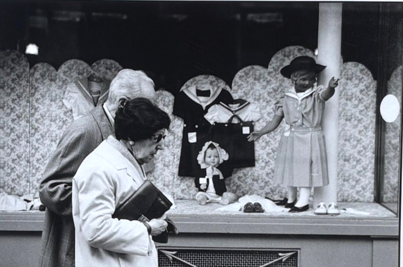 Old Couple Passing Store Window with Dolls-Paris-Photograph-1979-Mark Bugzester