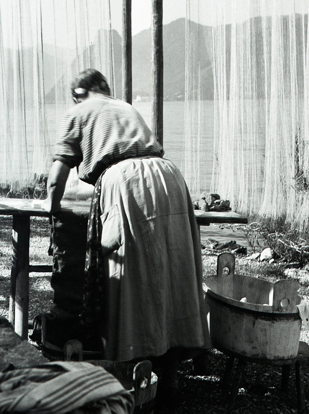 Salzkammergut , Austria, village, woman w traditional fishing net, by Eduard PEZ