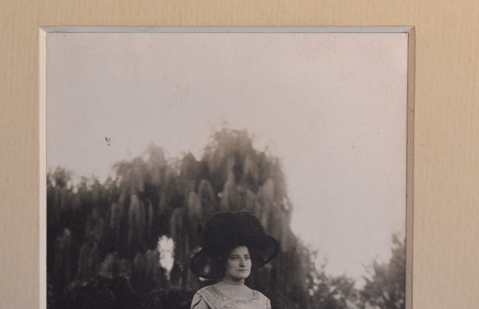 Vintage Photograph of a Woman Wearing a White Dress and a Black Hat