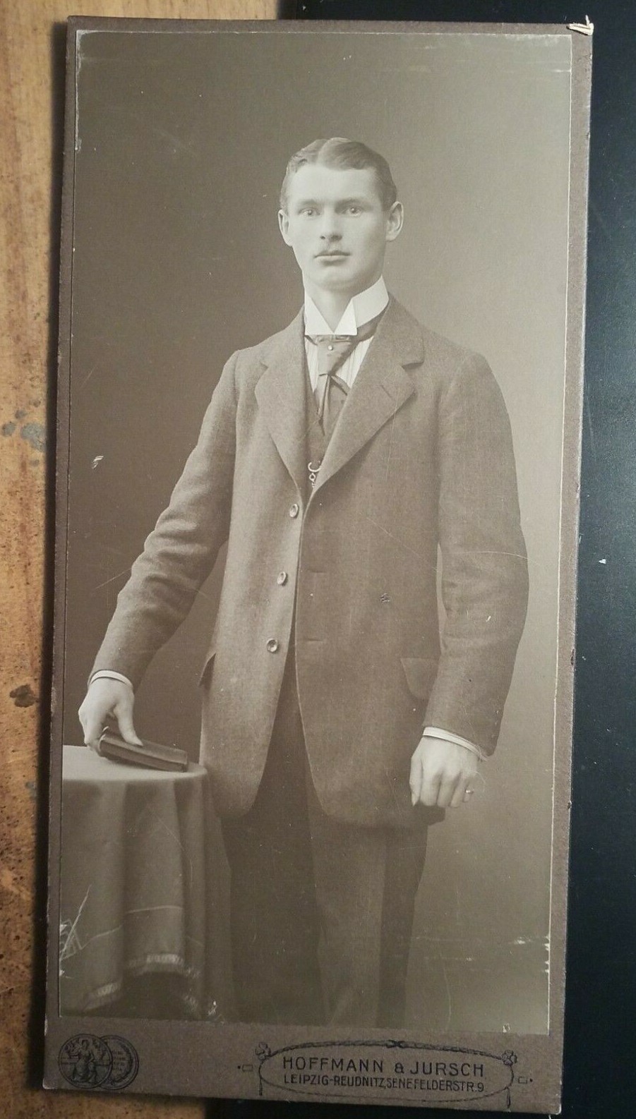standing young man with book in hand/KAB Hoffmann & Jursch Leipzig Reudnitz
