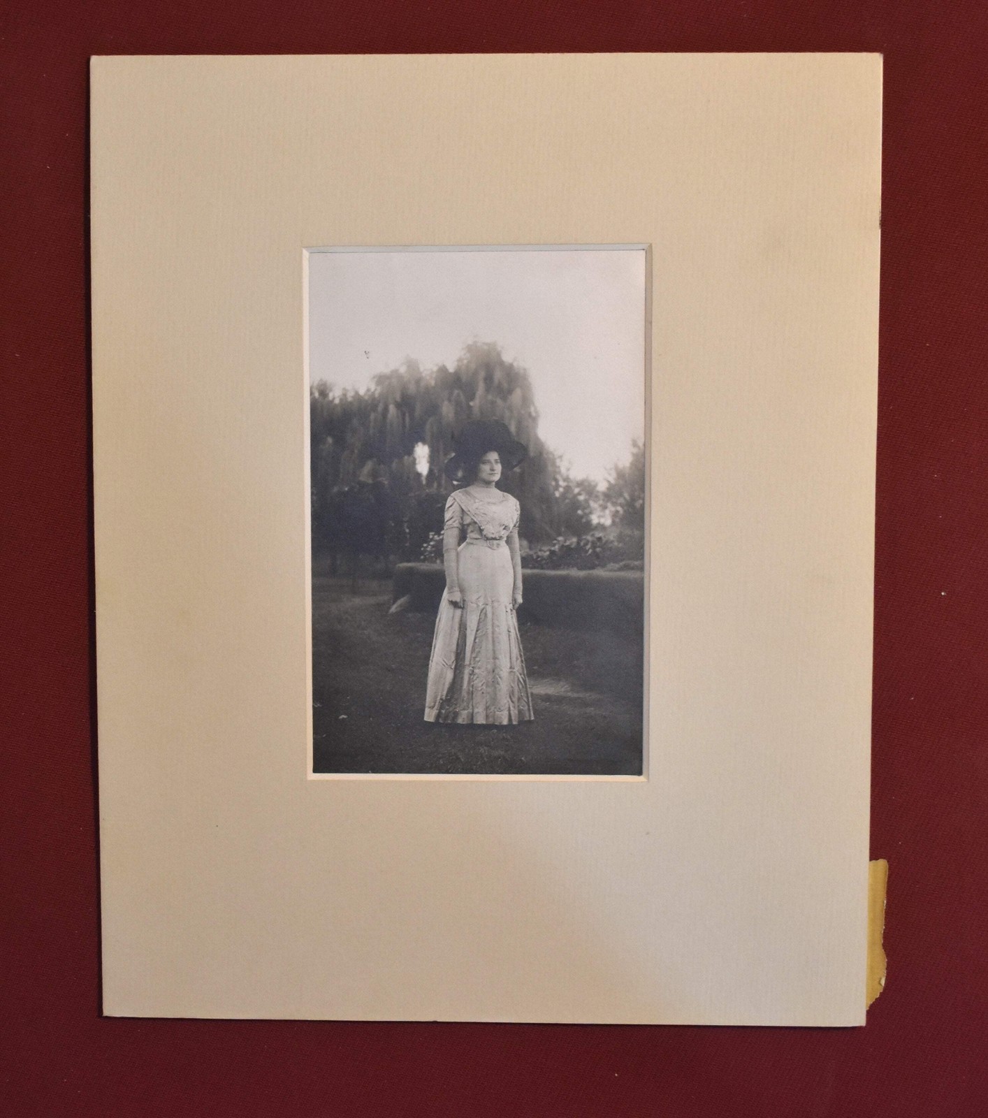 Vintage Photograph of a Woman Wearing a White Dress and a Black Hat