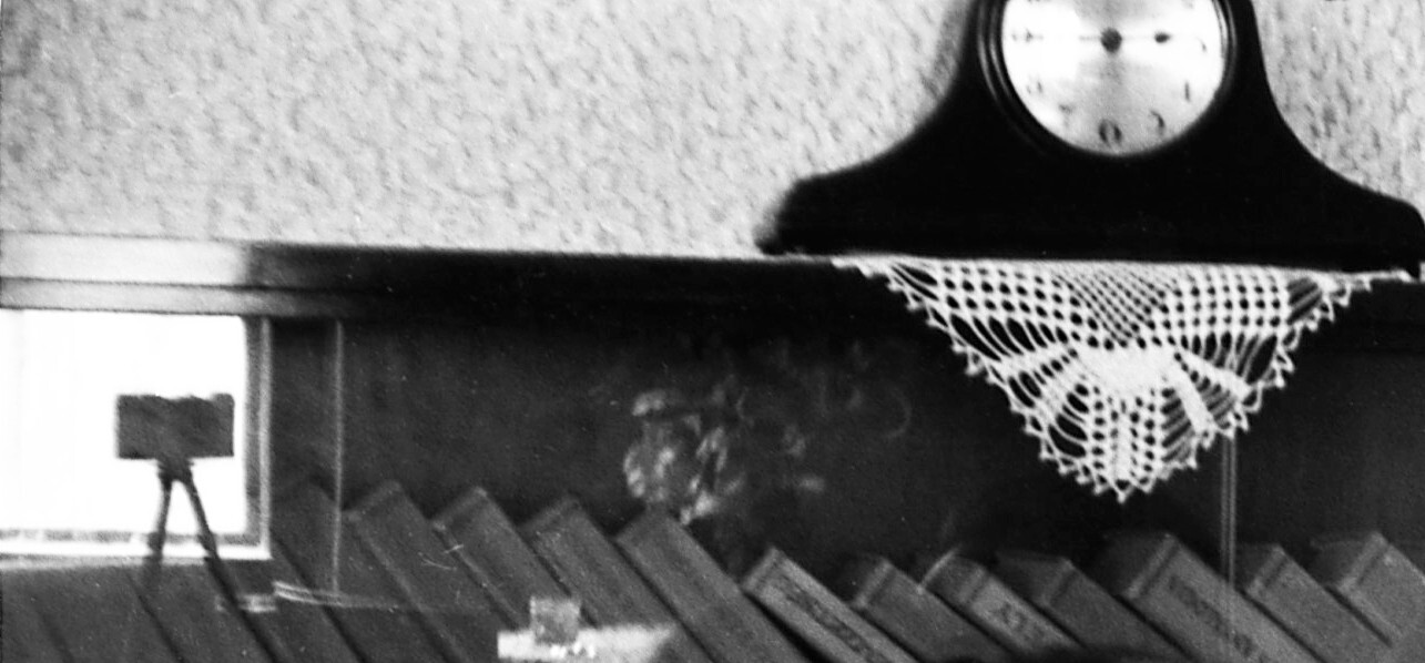 young couple kissing, photo camera on tripod, glass reflection, unusual, vintage